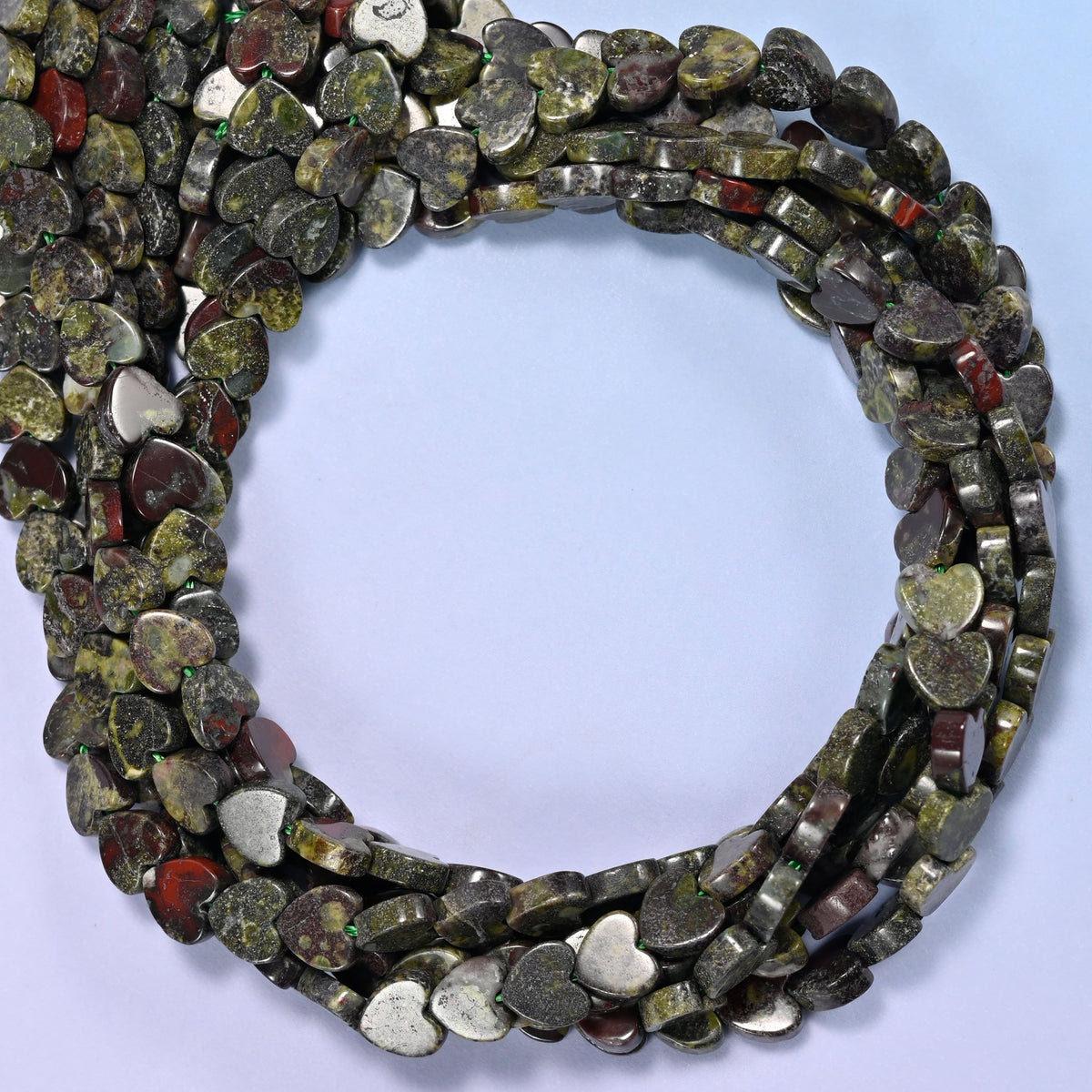 Dragon Bloodstone flat heart beads, close view of the coiled strands in mottled dark green with red-brown markings