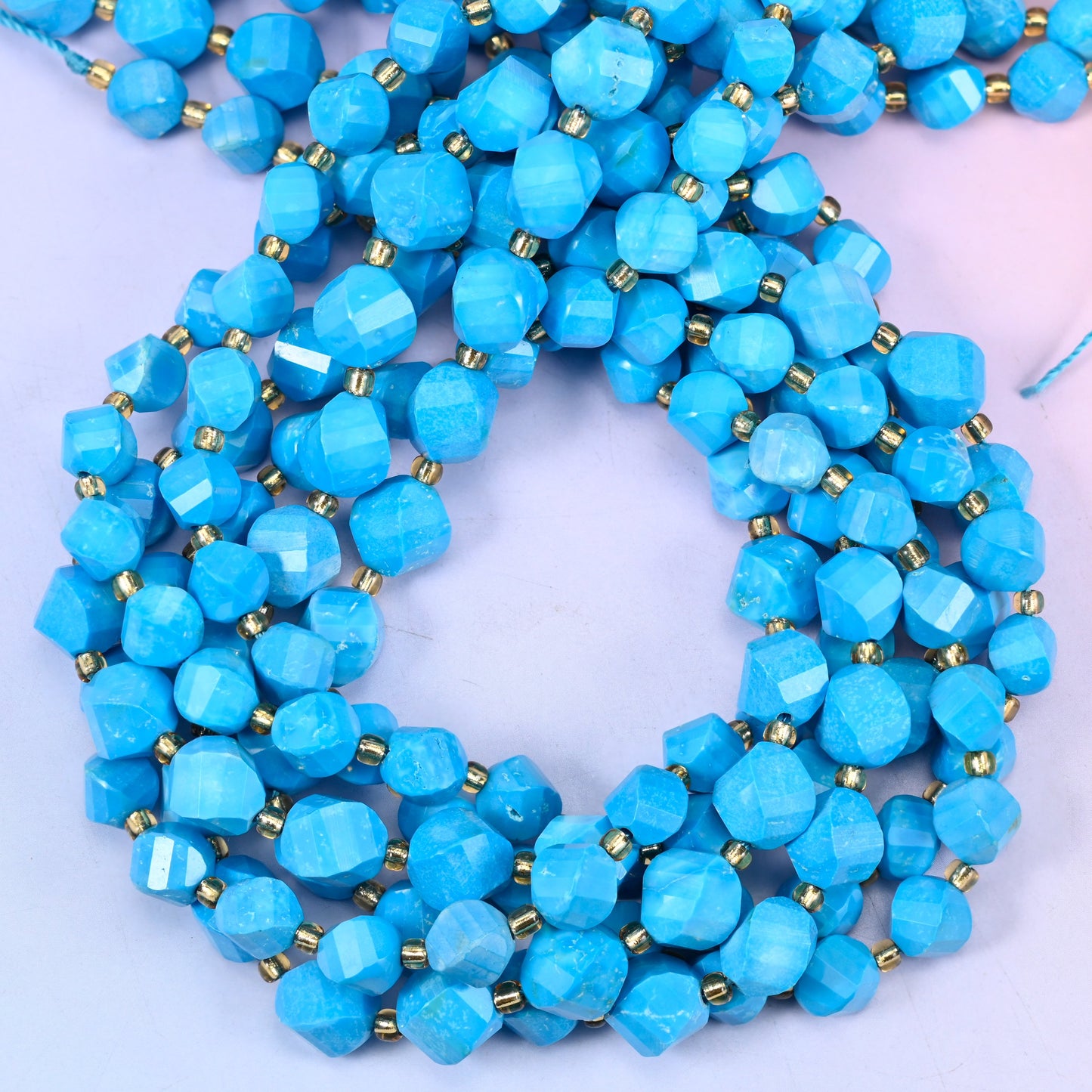 Dyed Blue Howlite faceted spiral twist beads, close view of the coiled strands showing the even bright blue colour