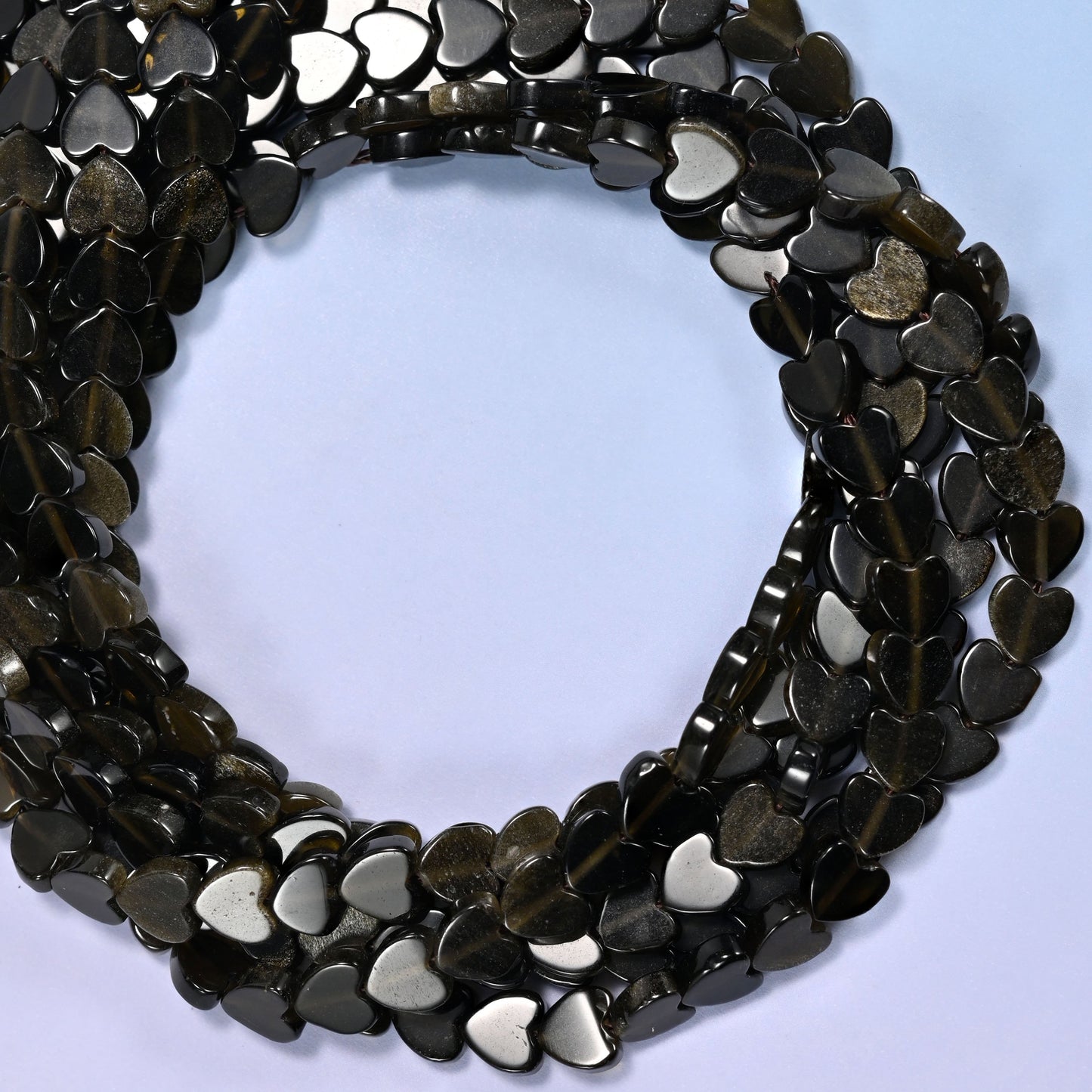 Gold Obsidian flat heart beads, close view of the coiled strands in glossy black with a bronze sheen