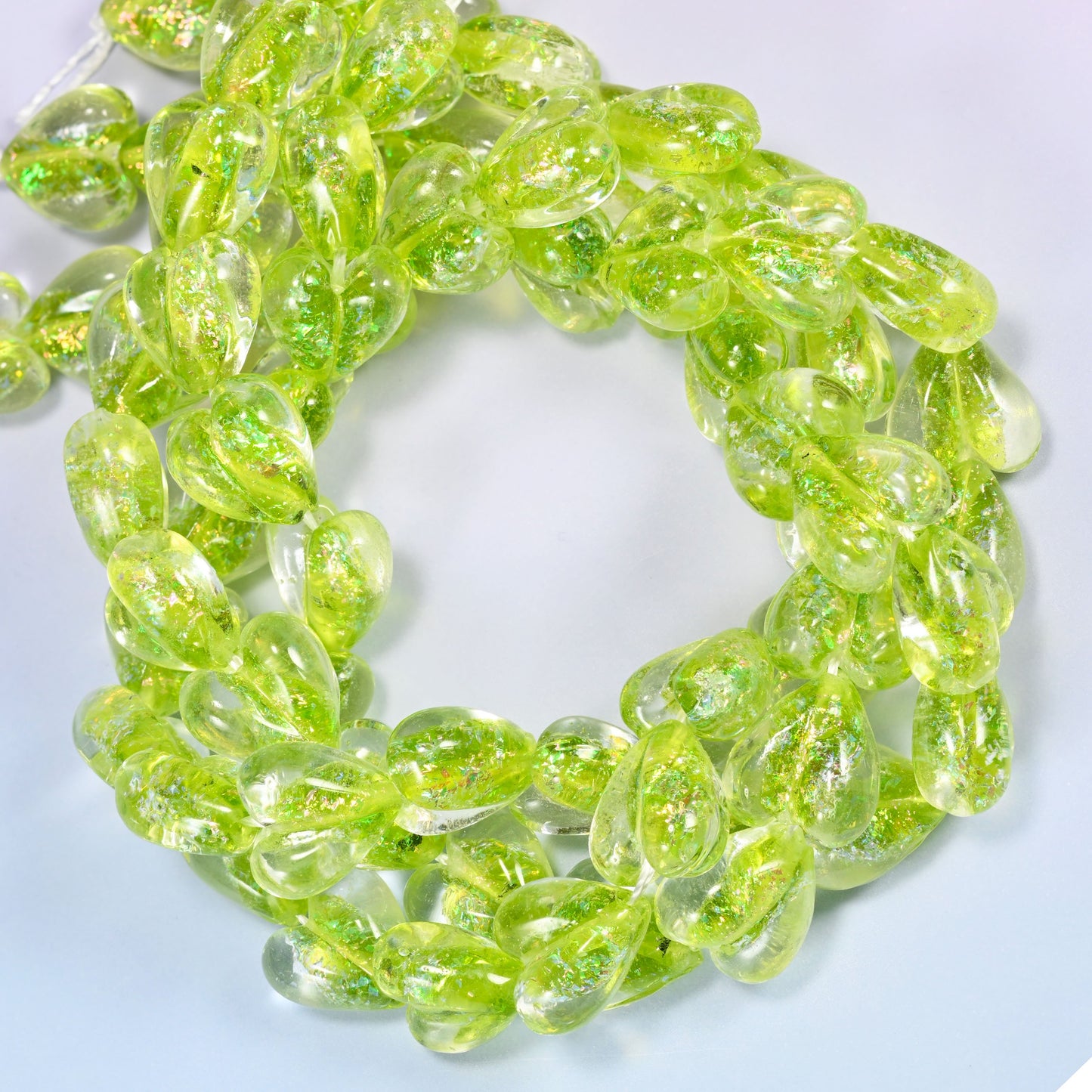 Iridescent Lime Green Heart glass beads, close view of the coiled strands in lime green with glitter inclusions