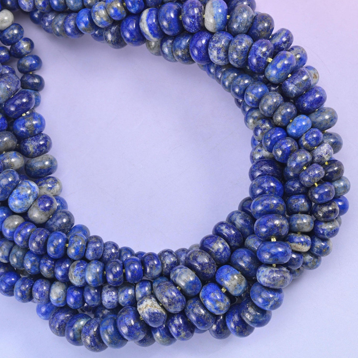 Lapis Lazuli smooth rondelle beads coiled into a loop, deep royal blue with gold pyrite flecks