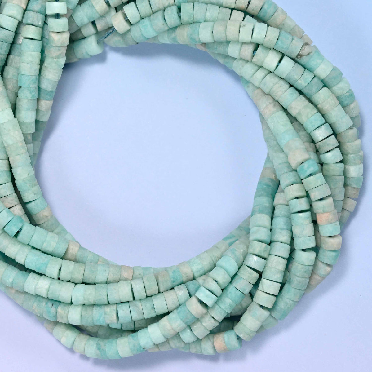Matte Blue Amazonite heishi disc beads, close view of the coiled strands showing the soft sea-green color
