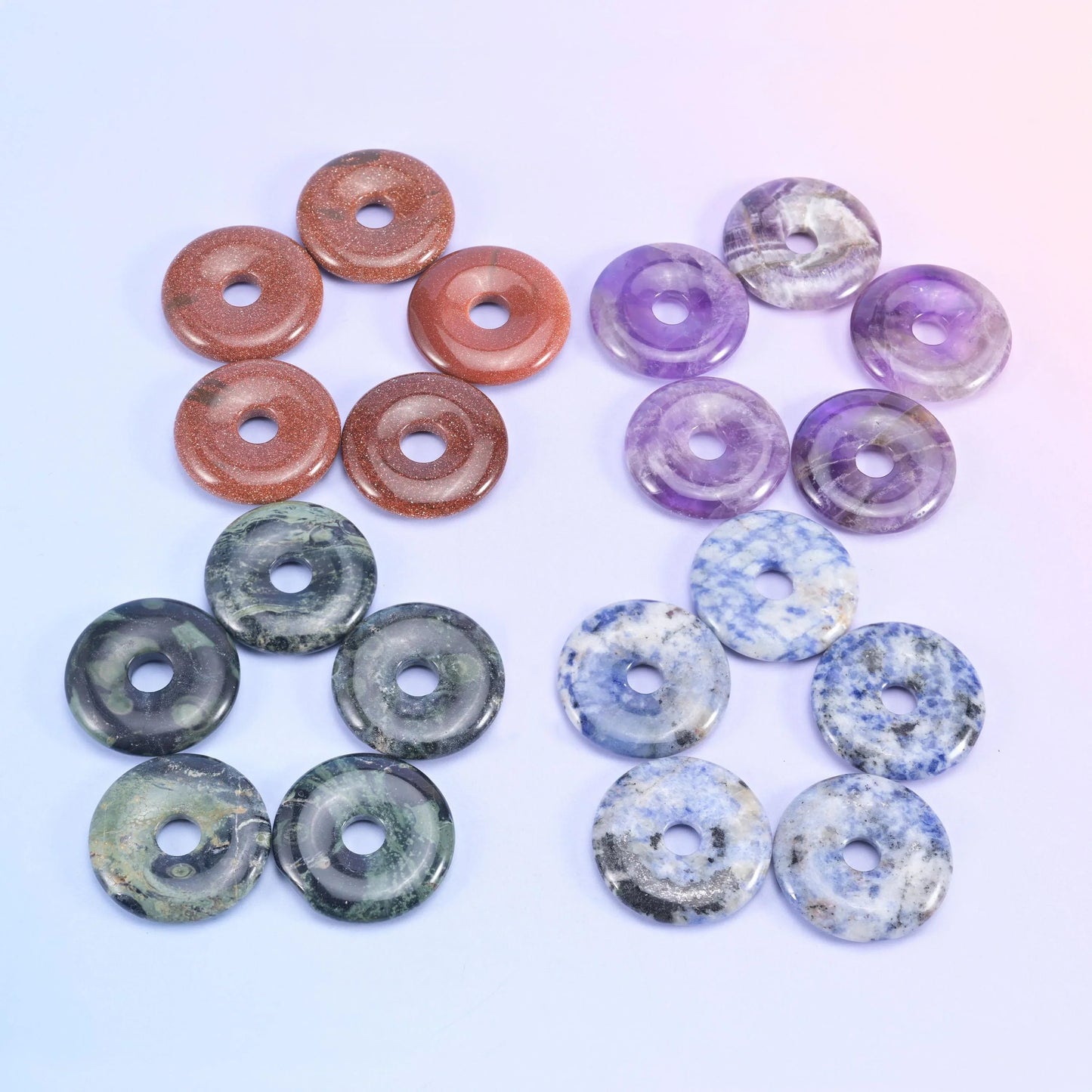Rust red, lavender amethyst, dark grey and mottled blue donuts arranged in clusters