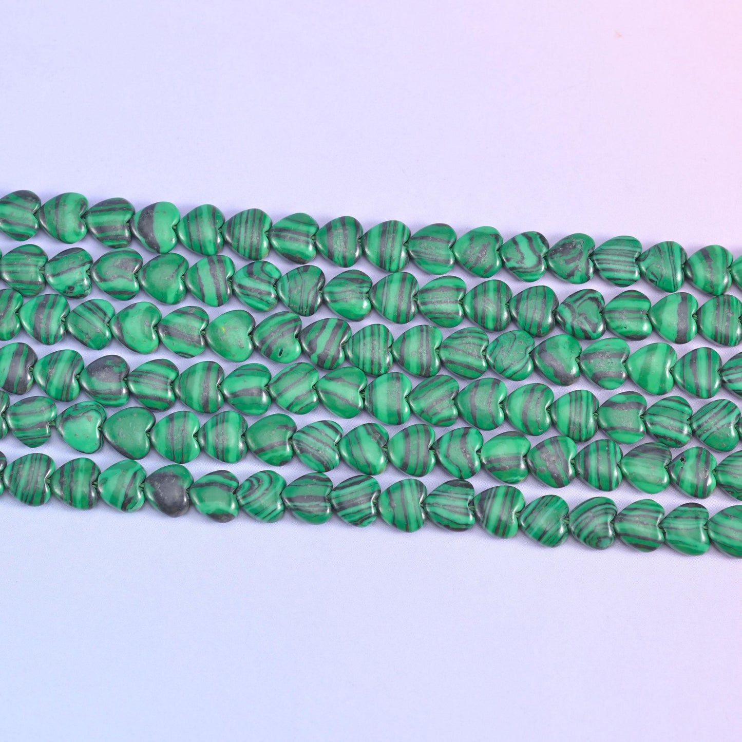 Green Malachite Heart Beads in vivid grass green with pale mint and near-black banding