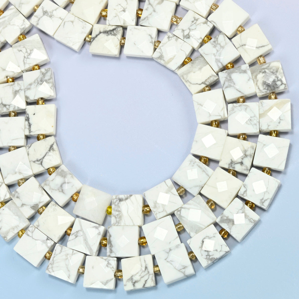 White howlite faceted flat square beads curved into an open loop, white beads with gray veins