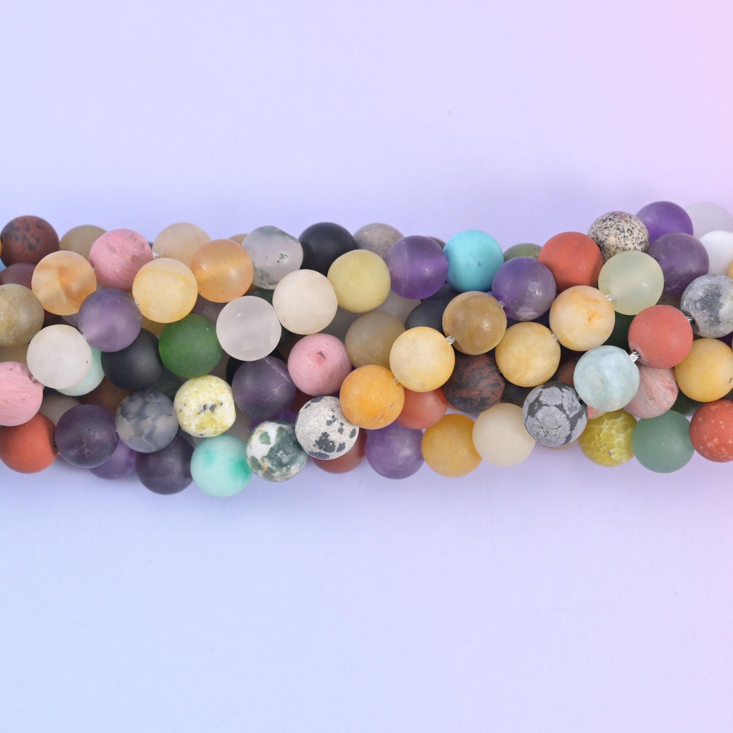 Close view of frosted matte rounds in turquoise, coral, mustard and sage