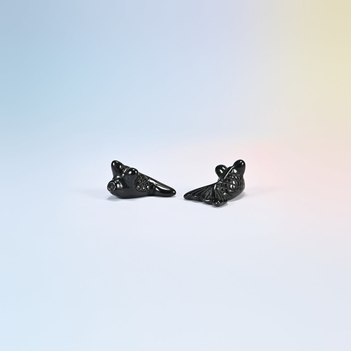 Two 1.5 inch natural black obsidian goldfish carvings, glossy black with a fan tail