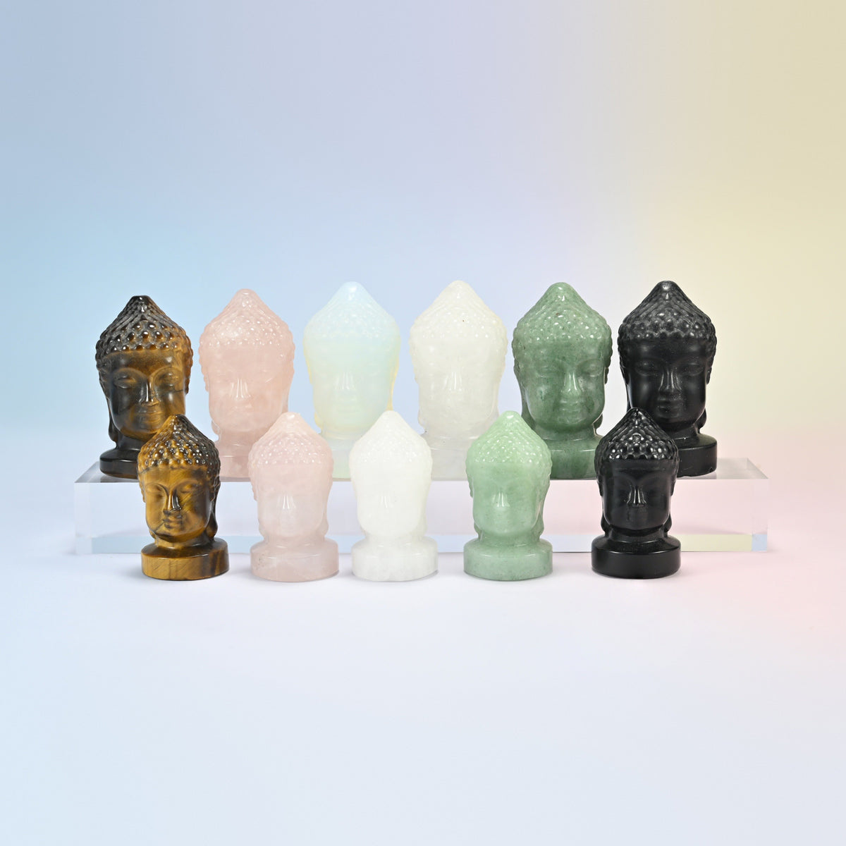 Buddha head crystal carvings in two sizes: natural tiger eye, rose quartz, clear quartz, green aventurine and black obsidian, plus opalite
