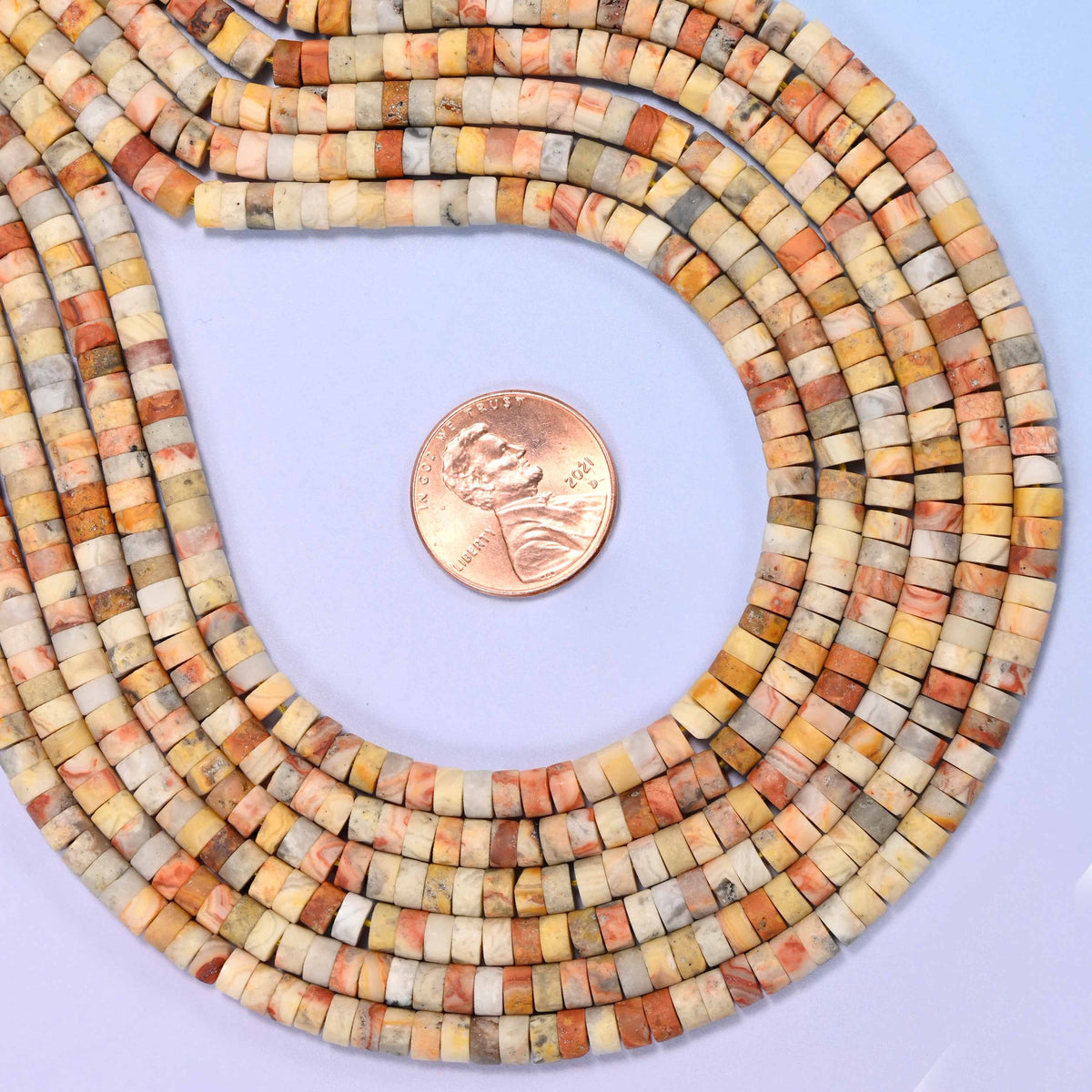 Natural crazy agate matte heishi disc beads in warm mustard, gray, cream and rust-red tones.