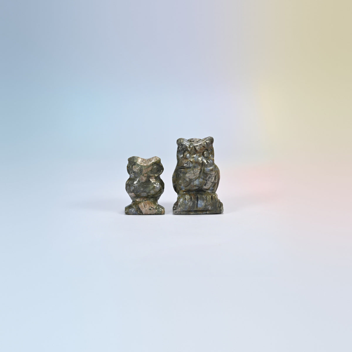 Owl crystal carving in blue labradorite, gray-green natural stone with a blue flash