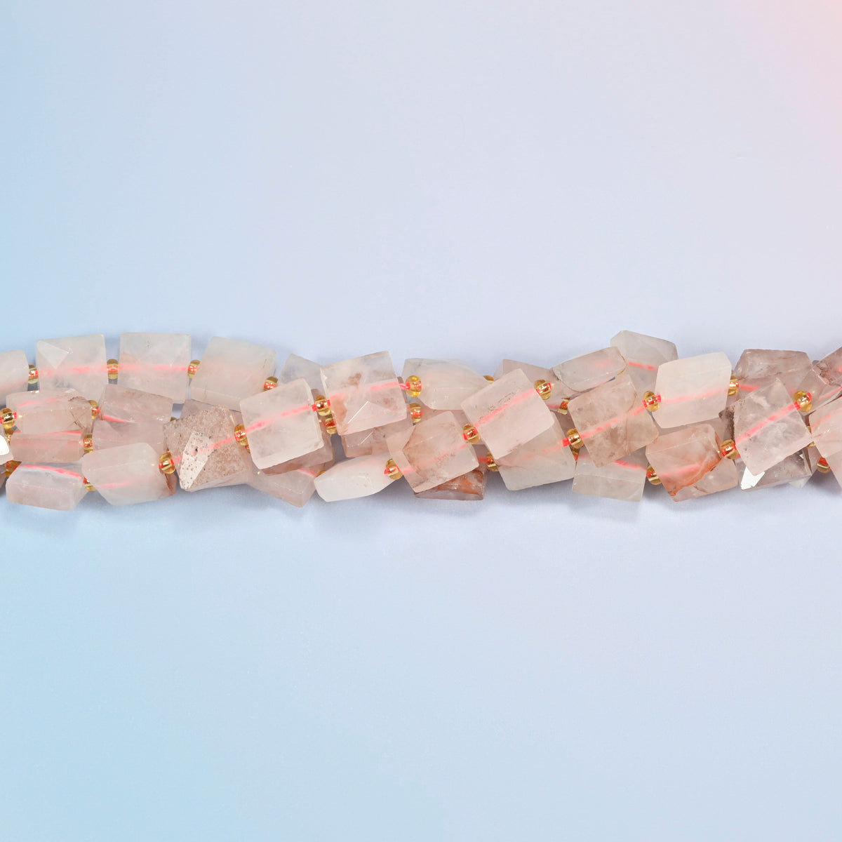 Strands of natural red hematoid quartz faceted flat square beads twisted together in a horizontal row
