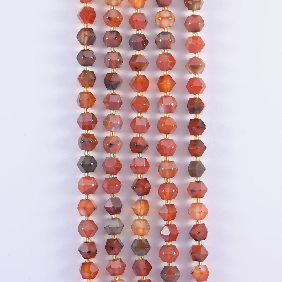 Faceted 8 sides diamond rhombus beads in dyed red strip agate in vertical rows, white banding crossing the orange.