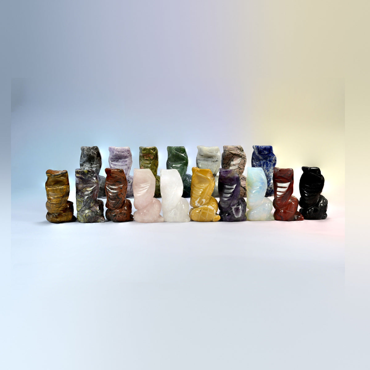 Group of 1.5 inch and 2 inch cobra crystal carvings in rose quartz, amethyst, tiger eye, moss agate, golden swan and more