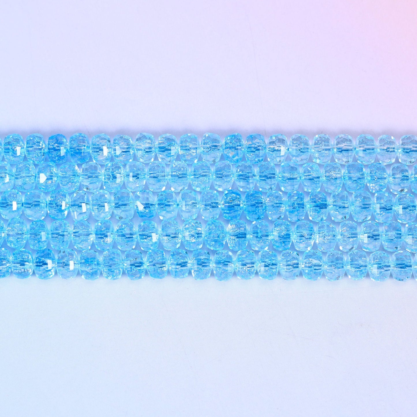 Transparent Blue Faceted Rondelle Glass Beads in a crisp aqua-blue tone