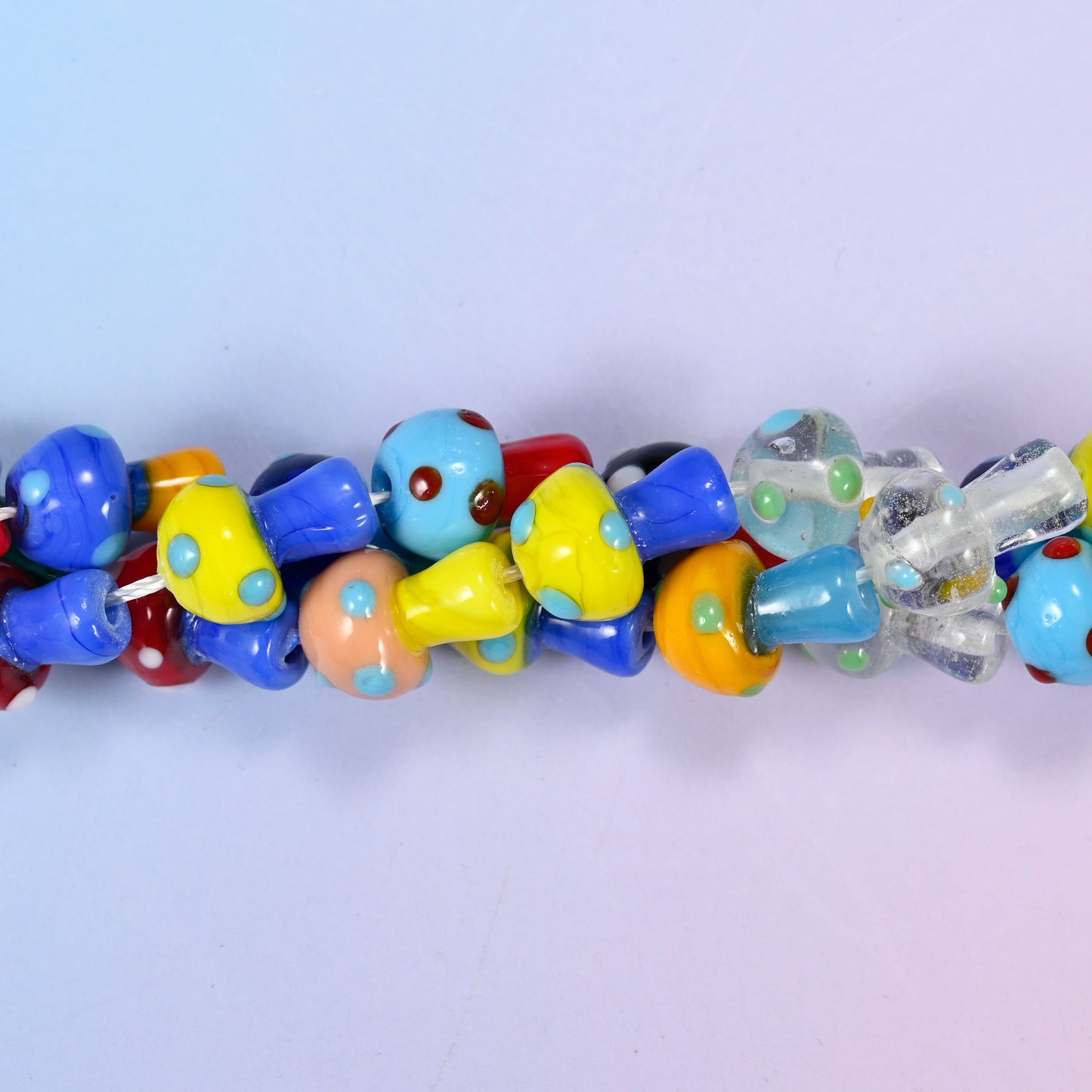 Mushroom-shaped lampwork glass beads with polka dot pattern