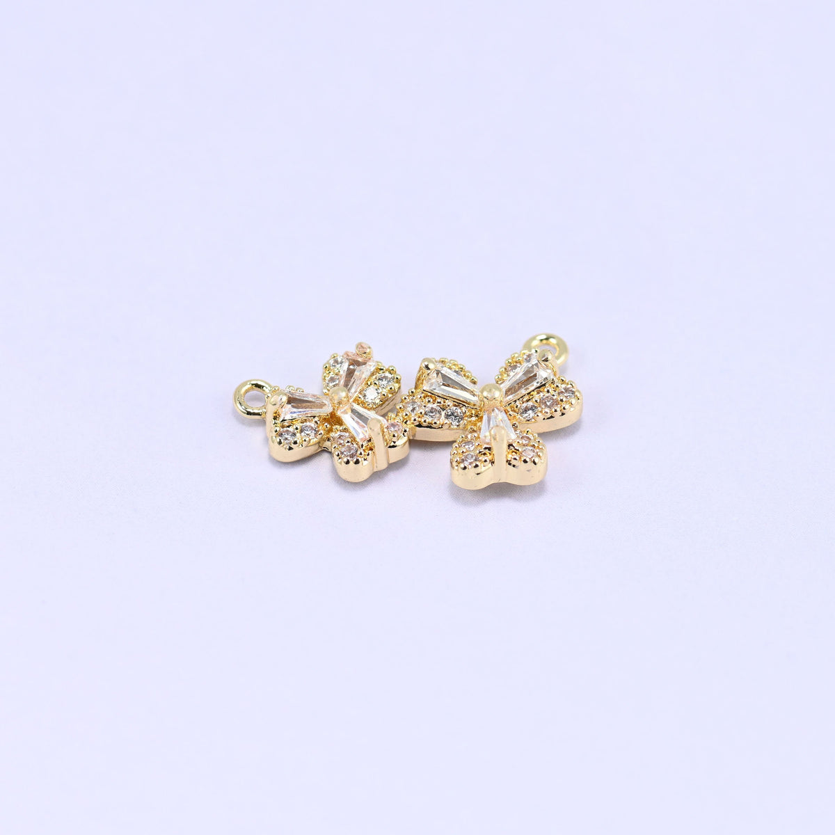 Three small blossoms pave set with clear zircon in a gently curved row