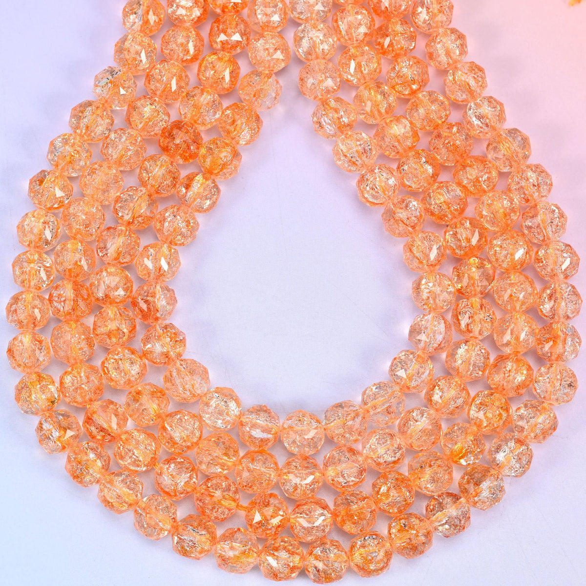 Faceted round cut transparent orange glass beads