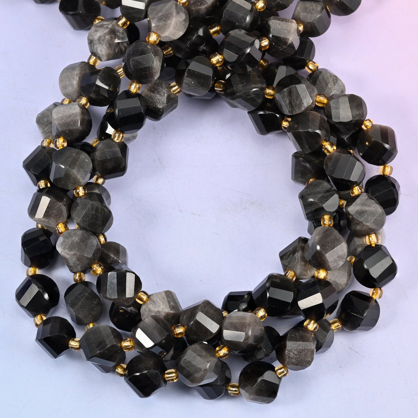 Natural silver obsidian stone beads in a 10mm faceted spiral twist cut