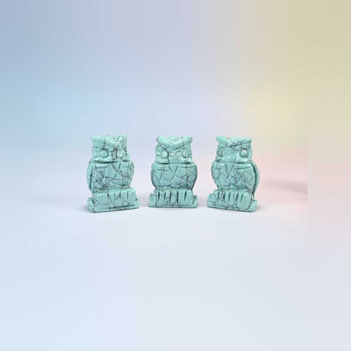 Owl crystal carving in dyed green howlite, turquoise green with dark veining