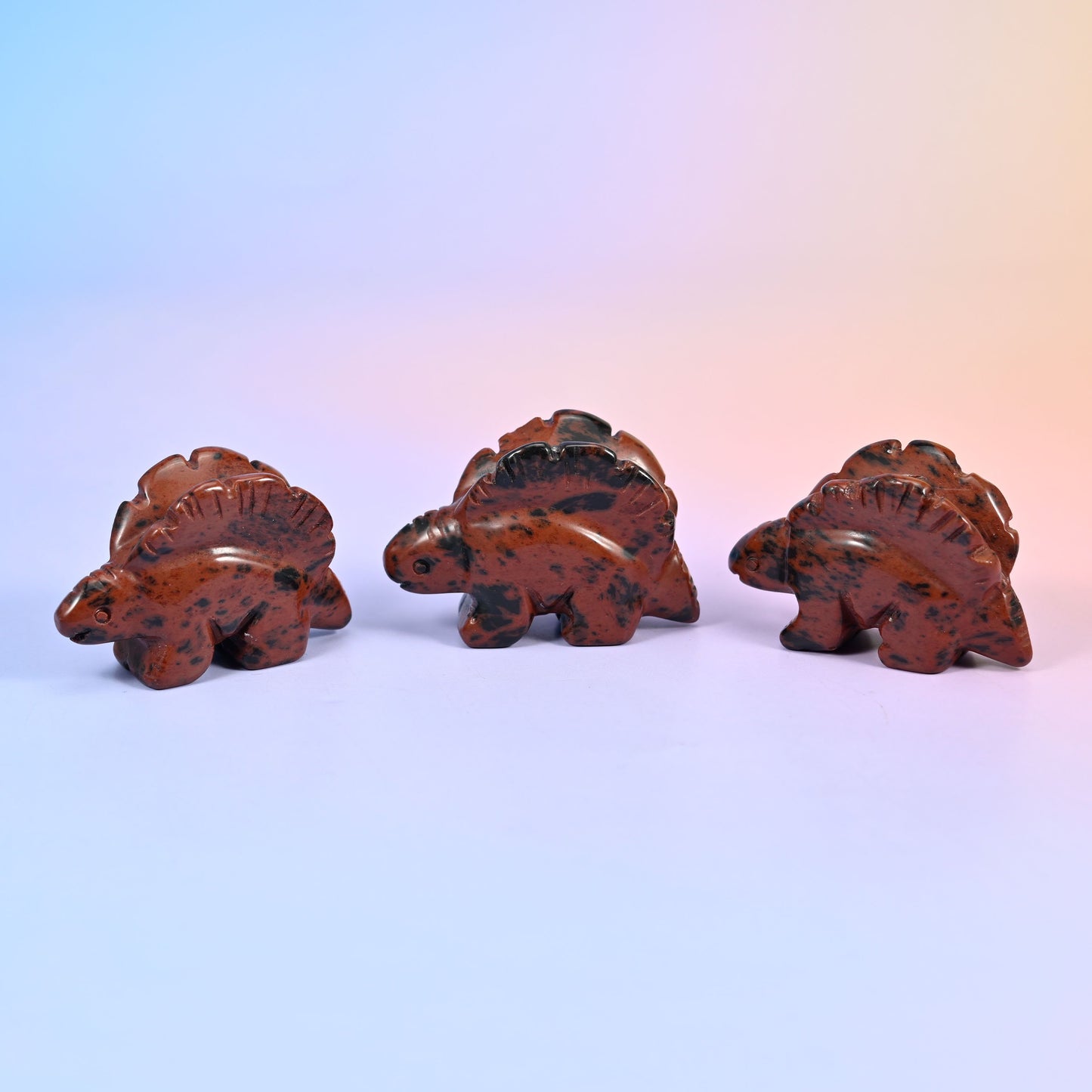 Stegosaurus carving offered in 12 natural stone options, from mint green and brick red to banded brown