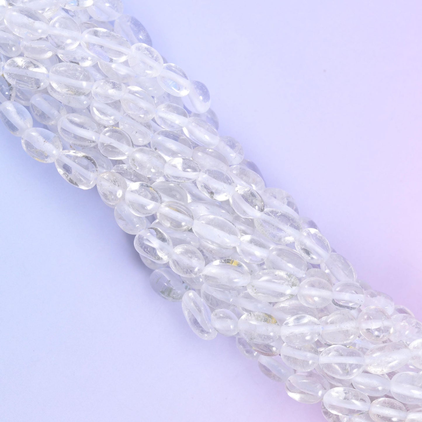 Strands running diagonally, light passing straight through the clearer beads