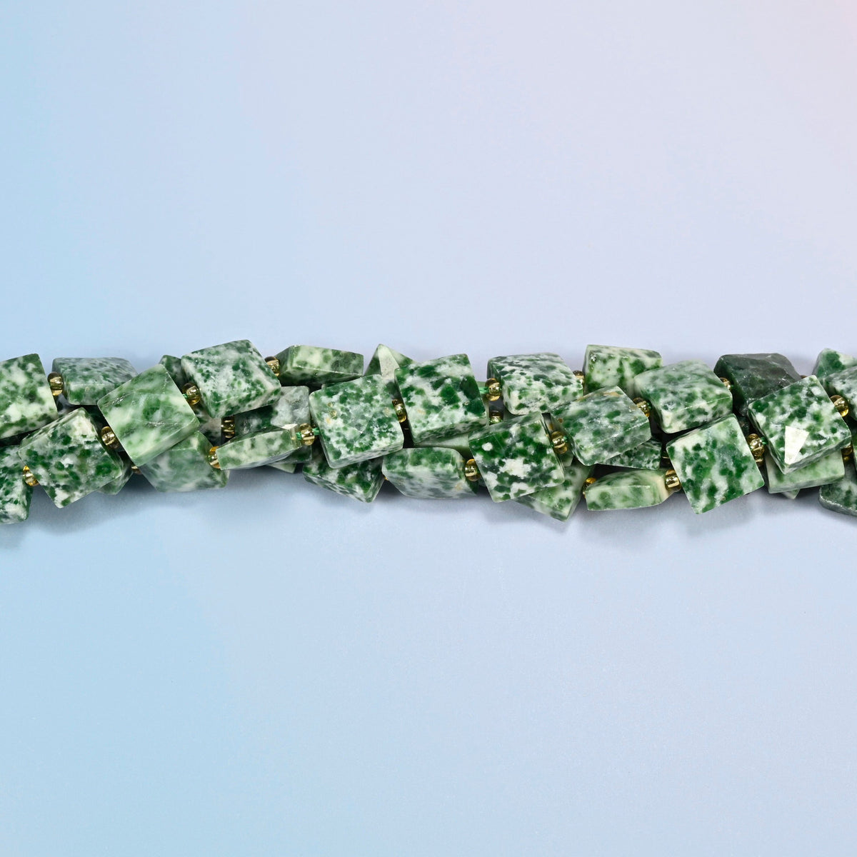 Strands of tree agate faceted flat square beads twisted together in a horizontal row