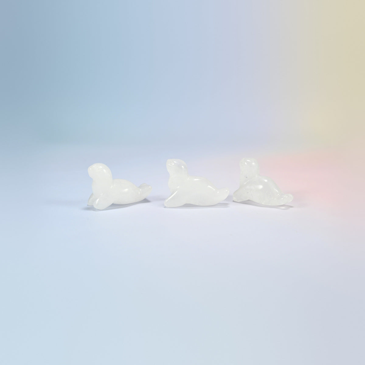 Three clear quartz sea lion crystal carvings, 1.5 inch, milky clear natural stone