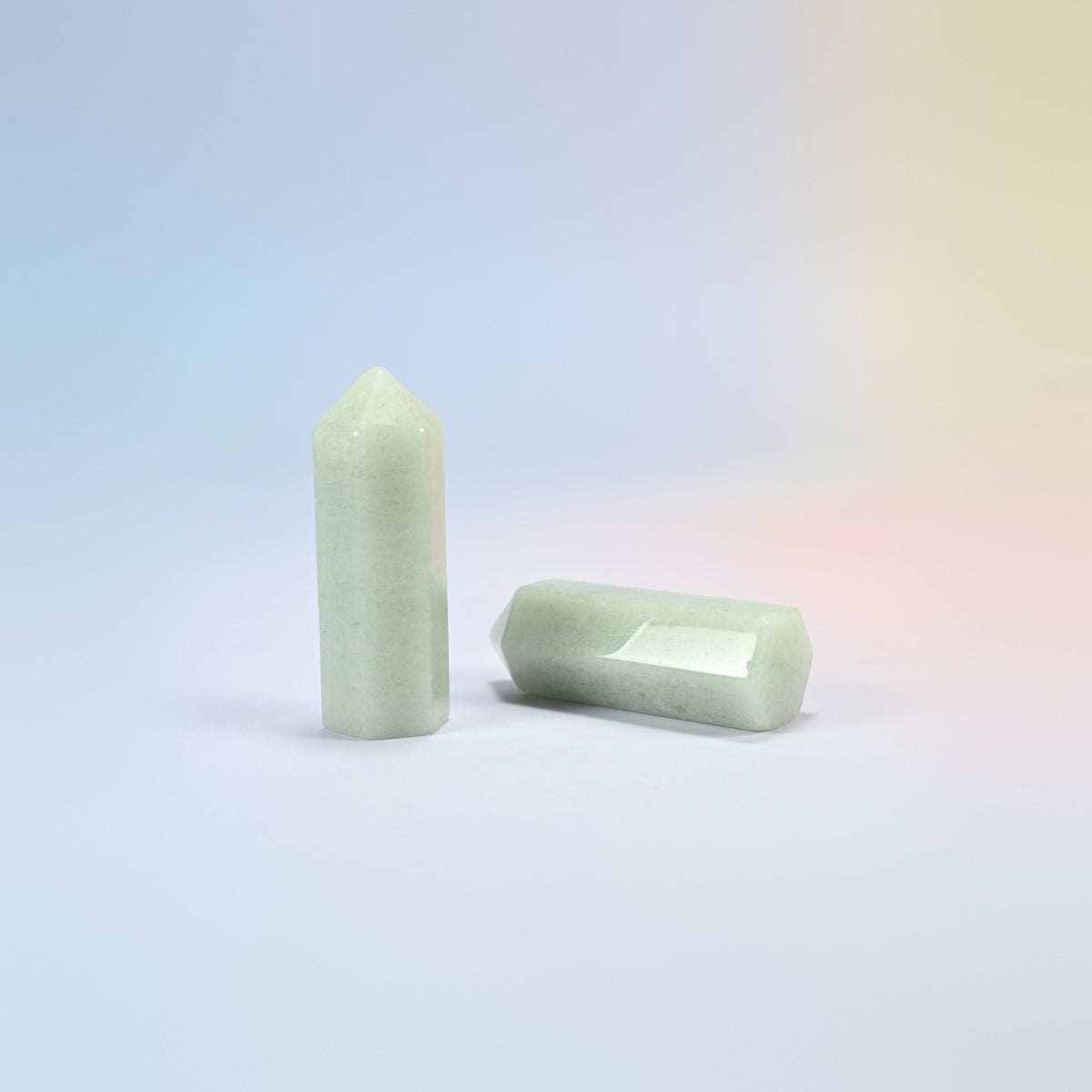 Natural green aventurine hexagon points in light mint green, one standing and one lying down