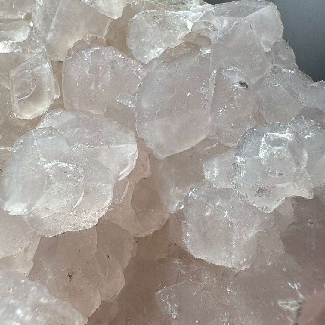 Close detail of semi-translucent calcite crystals with stepped rhombic faces