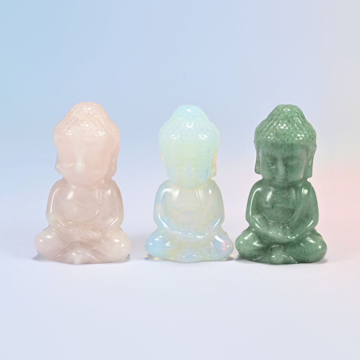 Three sitting Buddha crystal carvings: natural rose quartz, opalite and natural green aventurine, 2 inch