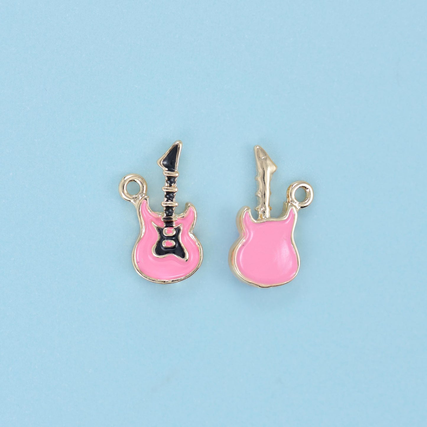 A little electric guitar with a glossy enamel body outlined in 18K gold filled brass