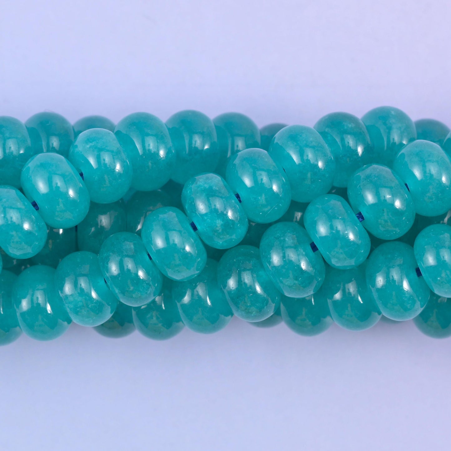 Smooth rondelle cut dyed jade beads with a polished surface