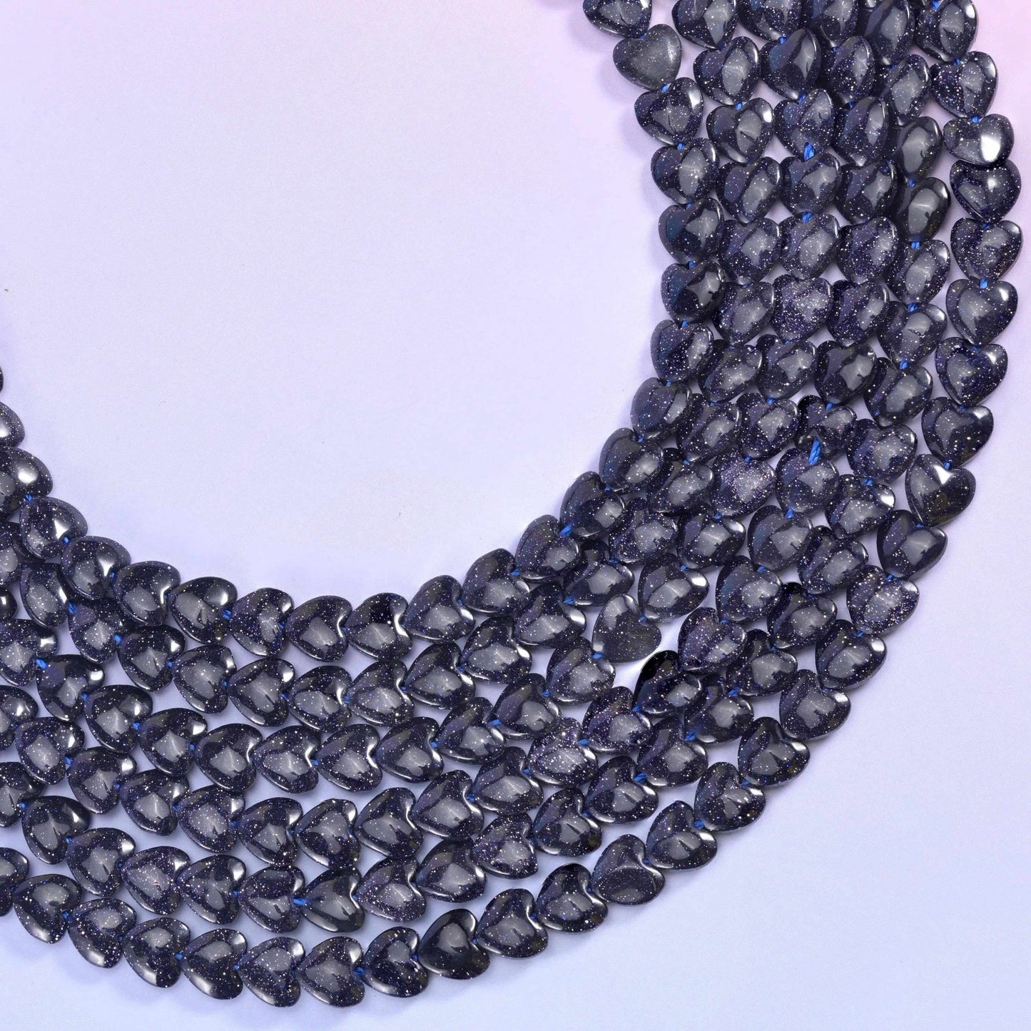 Blue Sandstone (man-made glass) hearts, midnight blue that reads almost black until copper sparkle catches the light
