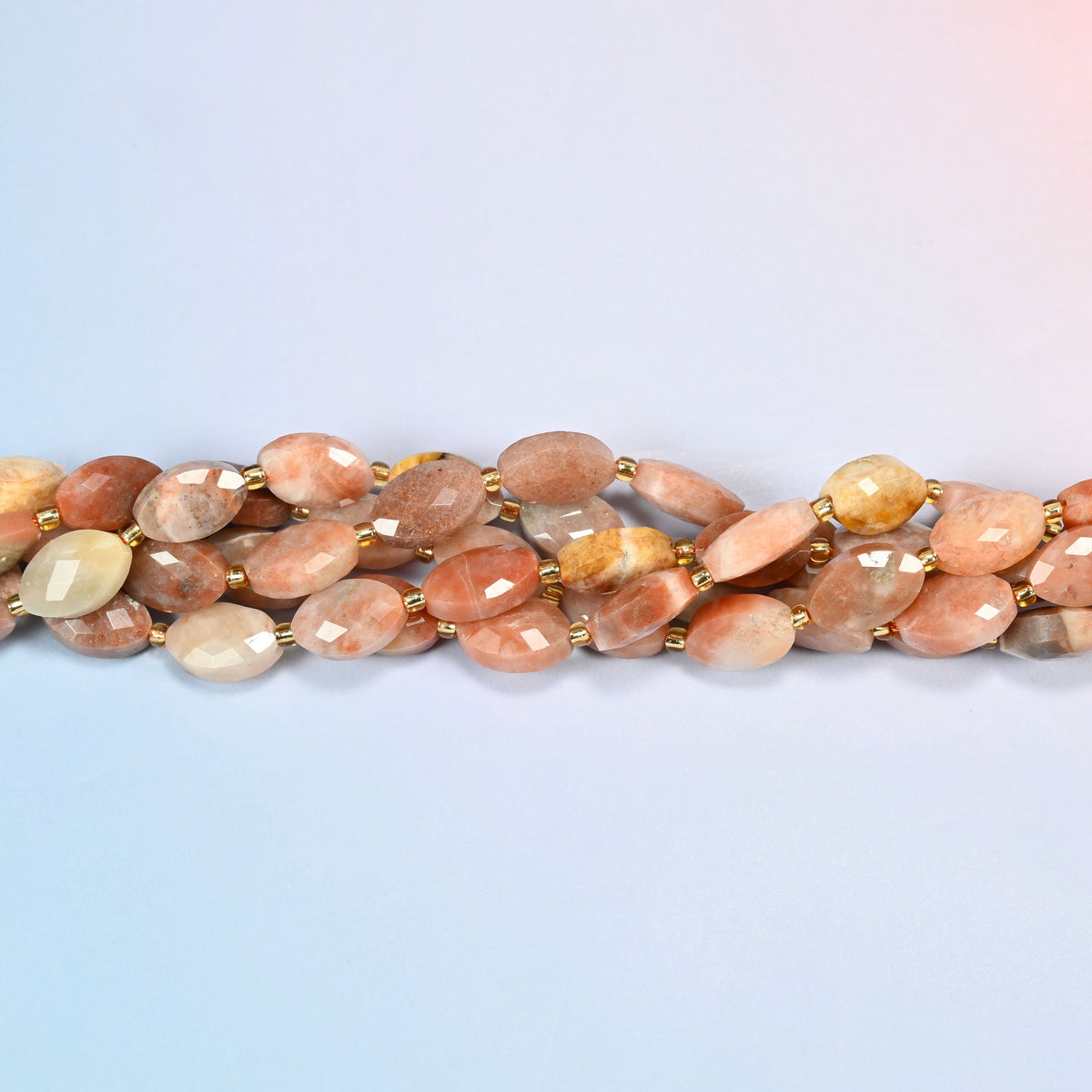 Strands of red crazy agate faceted flat oval beads twisted together in a horizontal row