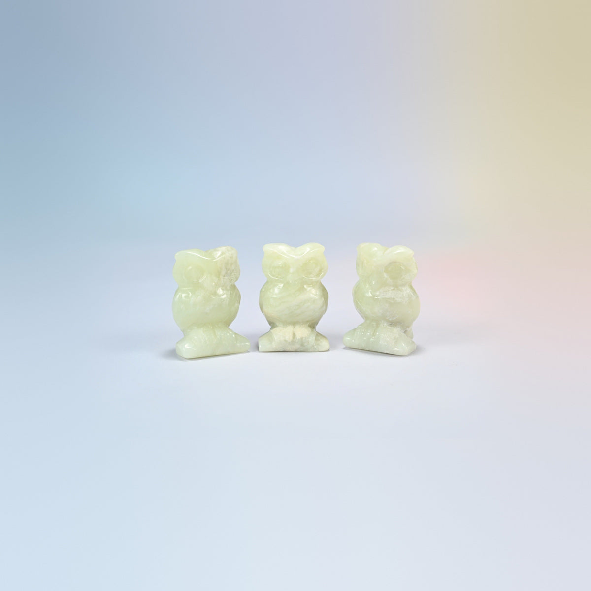 Owl crystal carving in new jade, pale yellow-green natural stone