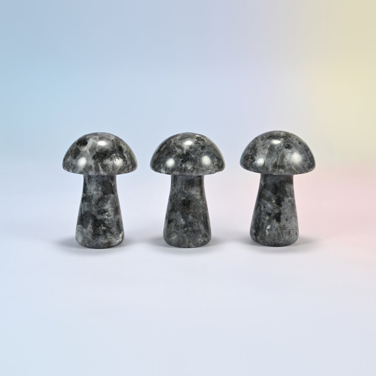 Three 2 inch black labradorite mushroom crystal carvings, dark gray natural stone with black and white speckles