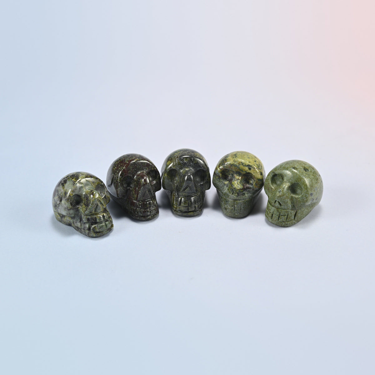 1 inch skull crystal carving in dragon bloodstone, dark green natural stone with red patches