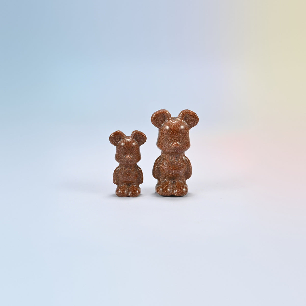 A 1.5 inch and a 2 inch gold sandstone power bear carving, brown man-made glass with gold sparkle