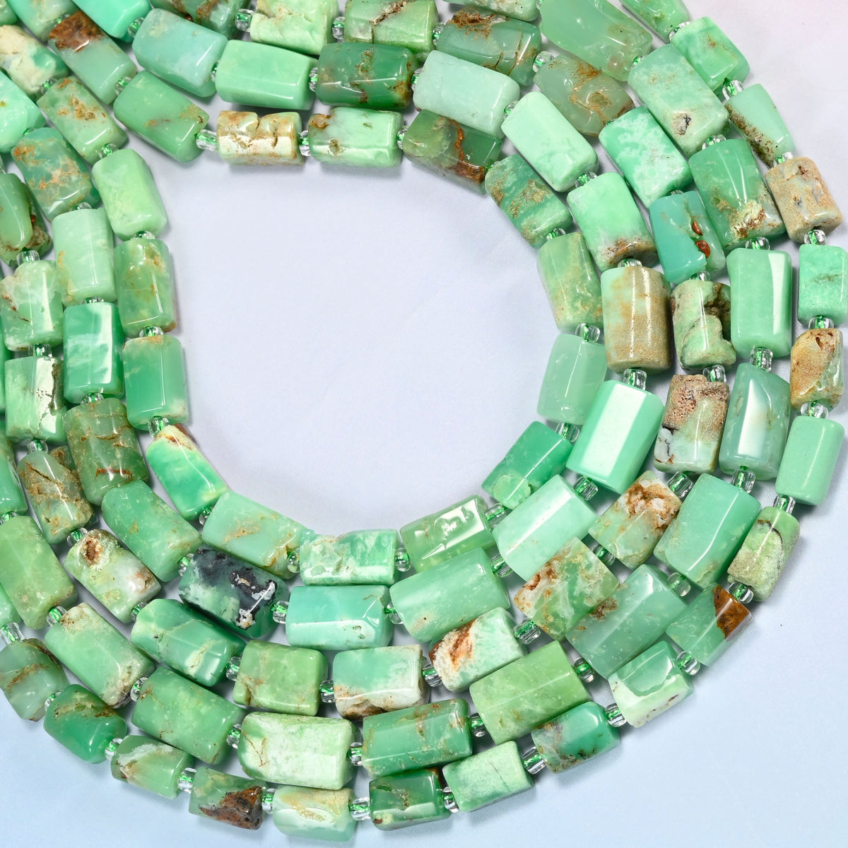 Australian jade faceted tube beads curved into an open loop, mint, apple green and brown beads