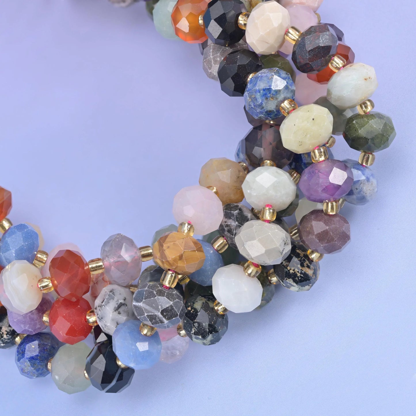 Faceted rondelle cut mixed natural gemstones including sodalite, red jasper and rose quartz beads