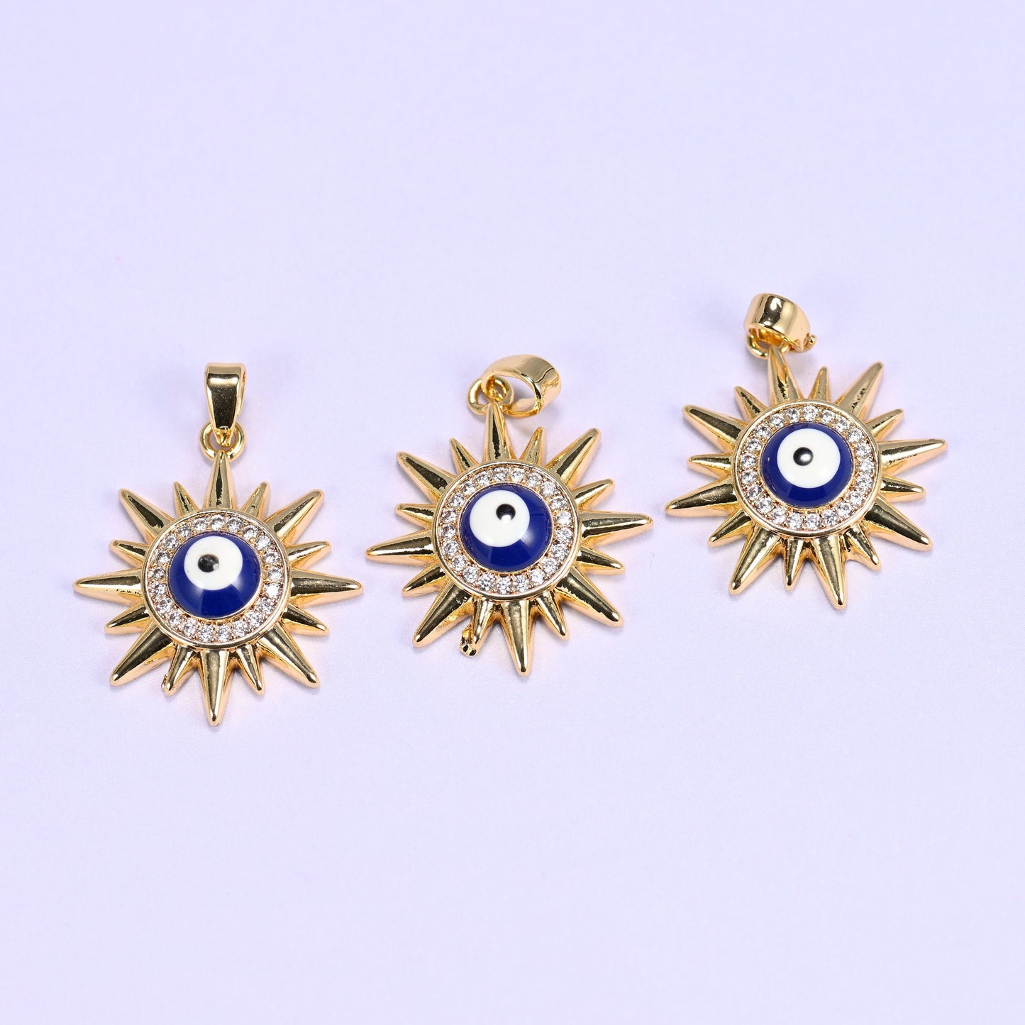 Evil Eye Sun Zircon Charms in gold, blue, and white