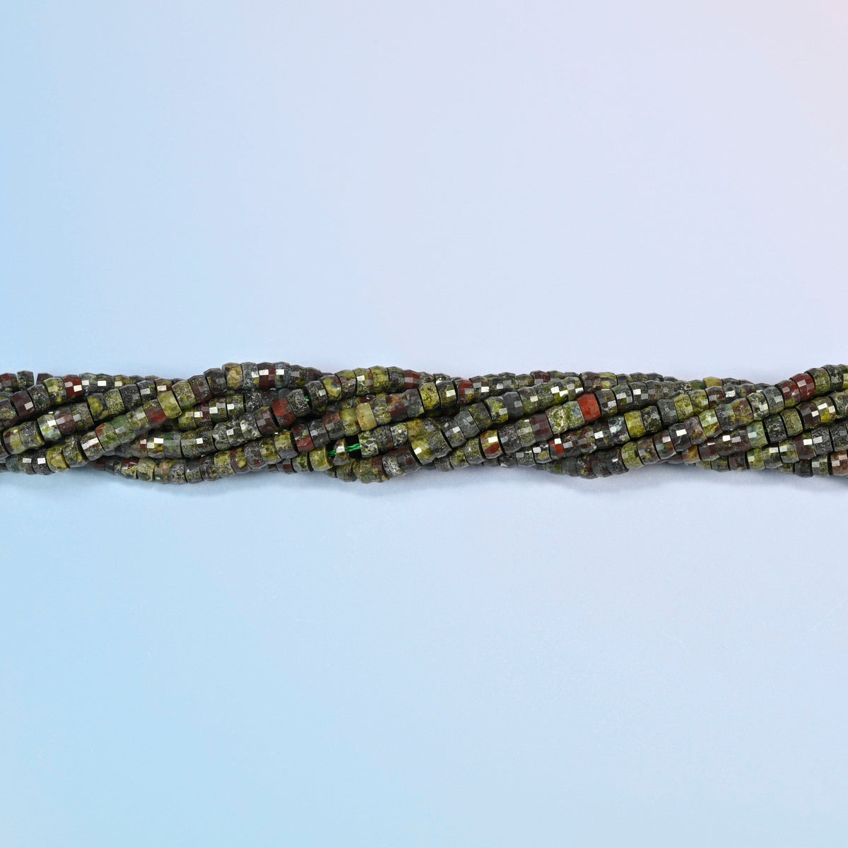 Strands of dragon blood stone faceted heishi disc beads twisted together in a horizontal row