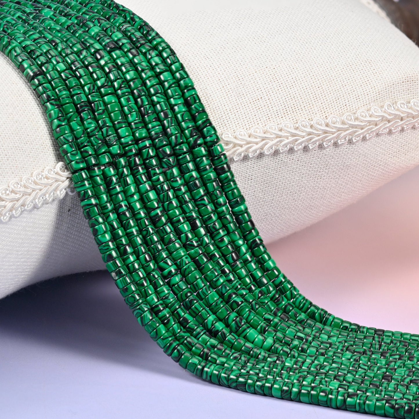 Reconstituted Malachite smooth heishi disc beads in vivid emerald green with bold black swirl banding