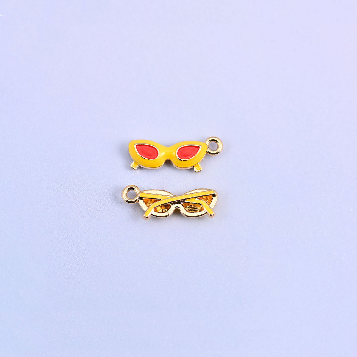 Yellow cat eye sunglasses charm with red lenses, shown front and back.