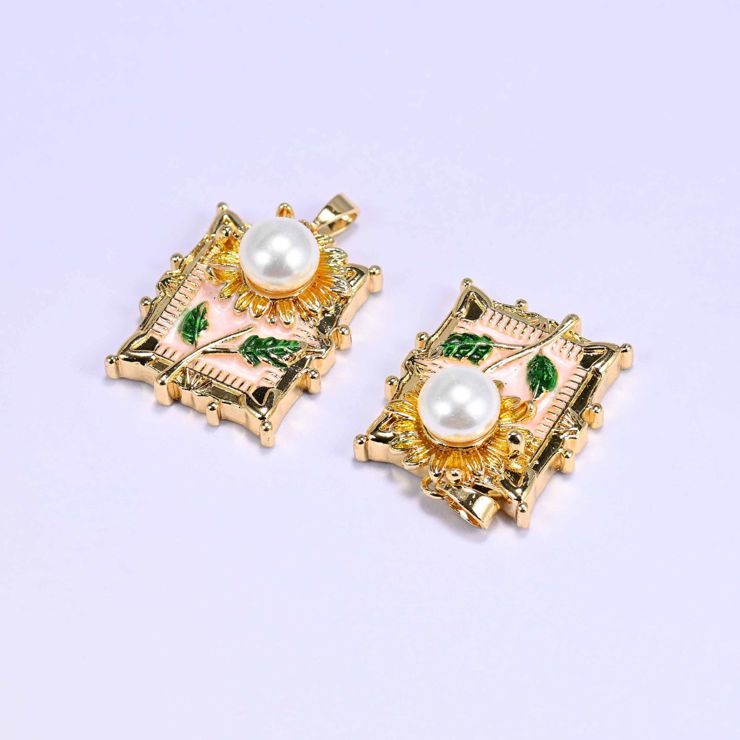 18K gold plated brass sunflower charm pendant with a faux pearl center, textured gold petals, pink enamel background, and green leaf details.