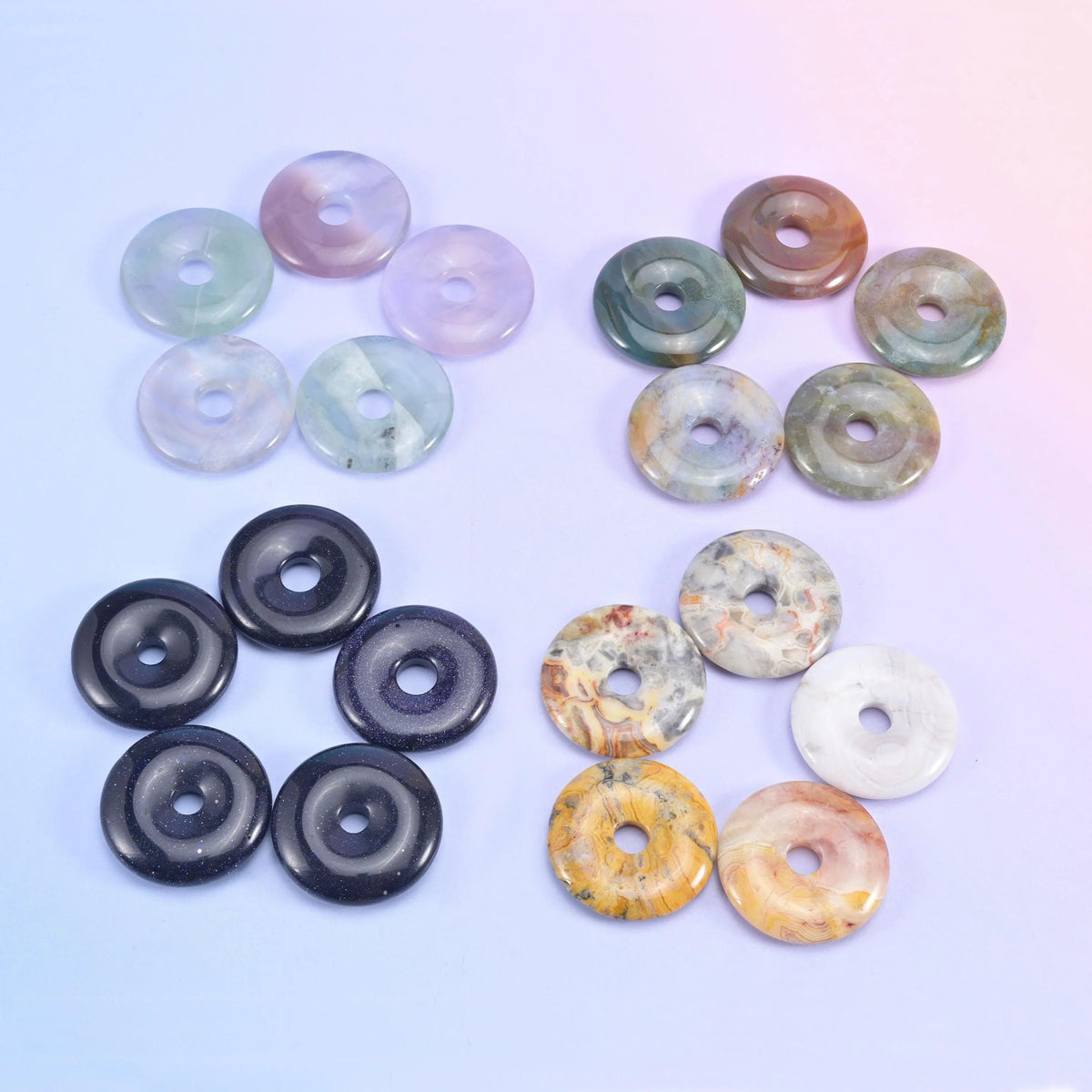 Pastel fluorite and pale green donuts next to jet black glass and golden yellow jade
