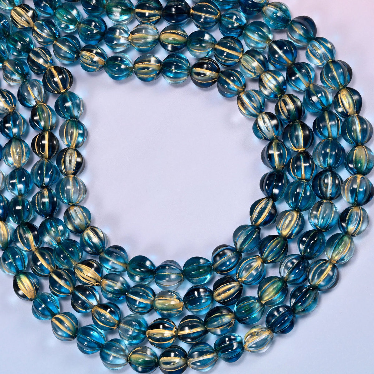 Dark blue gold pumpkin glass beads coiled into a wide open ring, gold ribs catching the light.