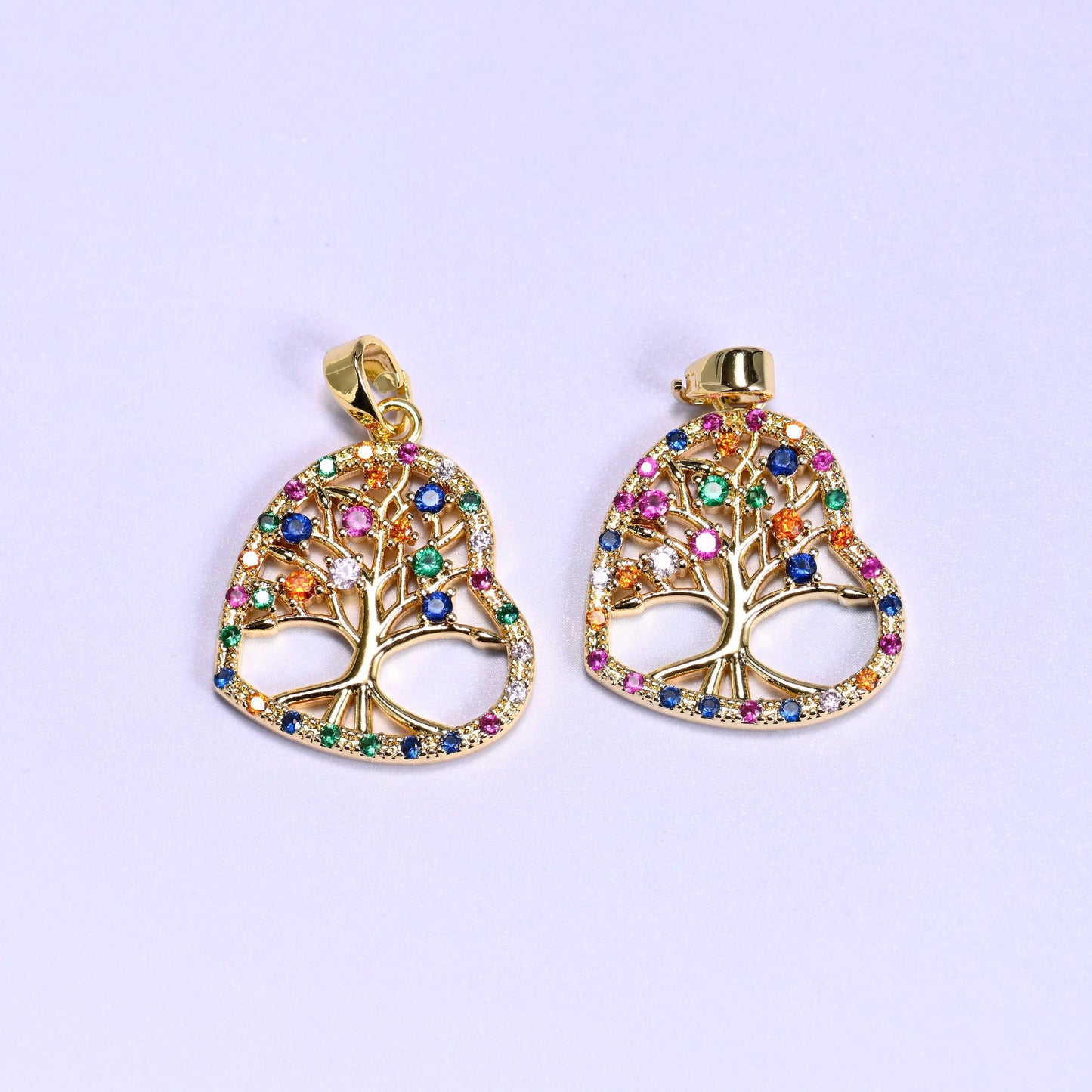 Openwork heart charm with a branch design outlined in multicolor zircon