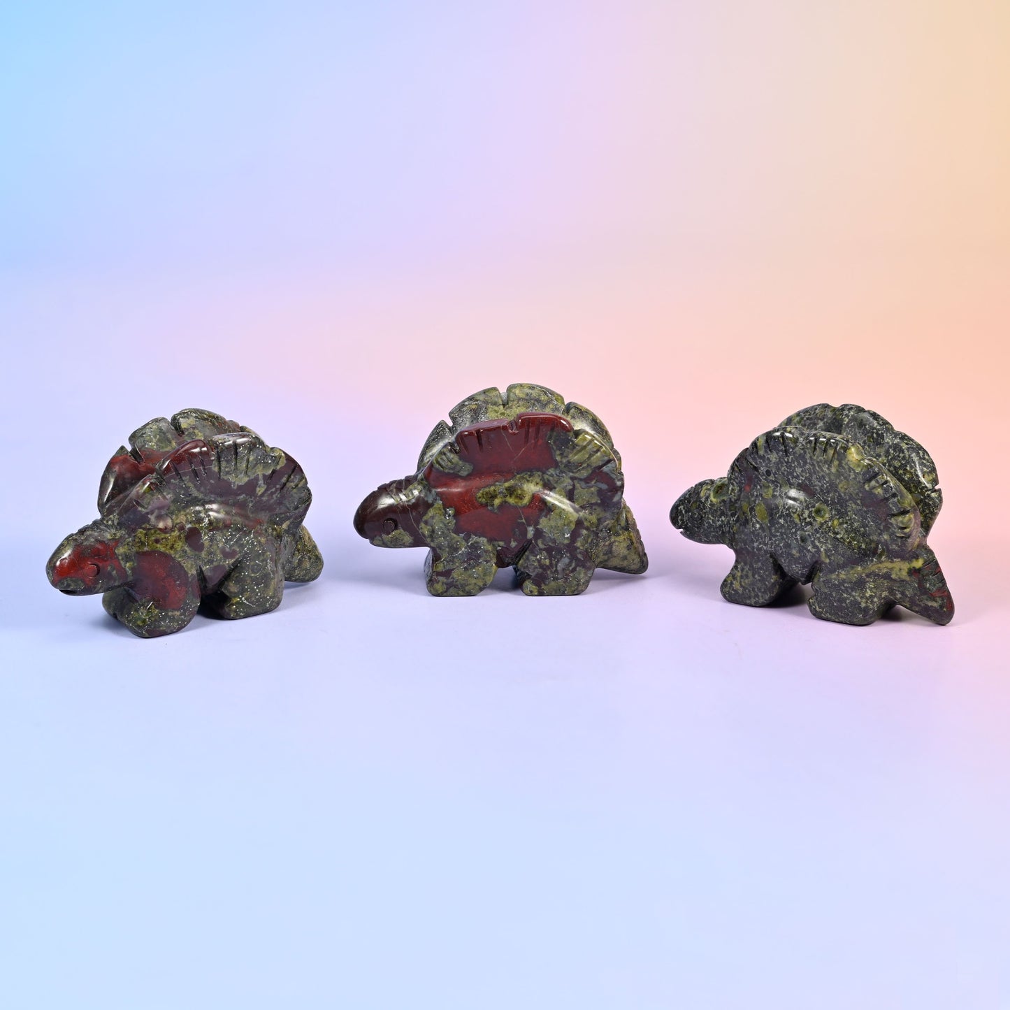 Stegosaurus carving offered in 12 natural stone options, from mint green and brick red to banded brown