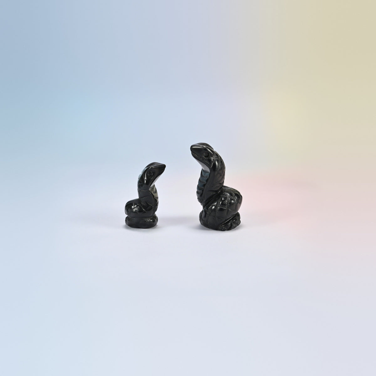 Cobra snake crystal carving in black obsidian, glossy black natural stone